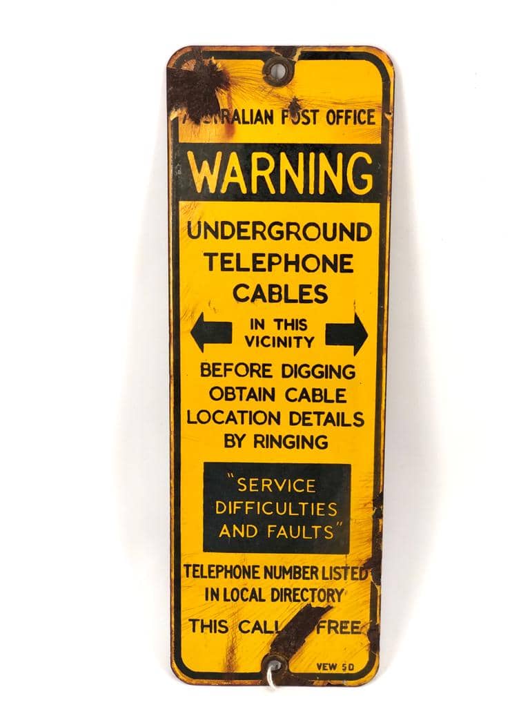 yellow and black enamelled australian warning sign